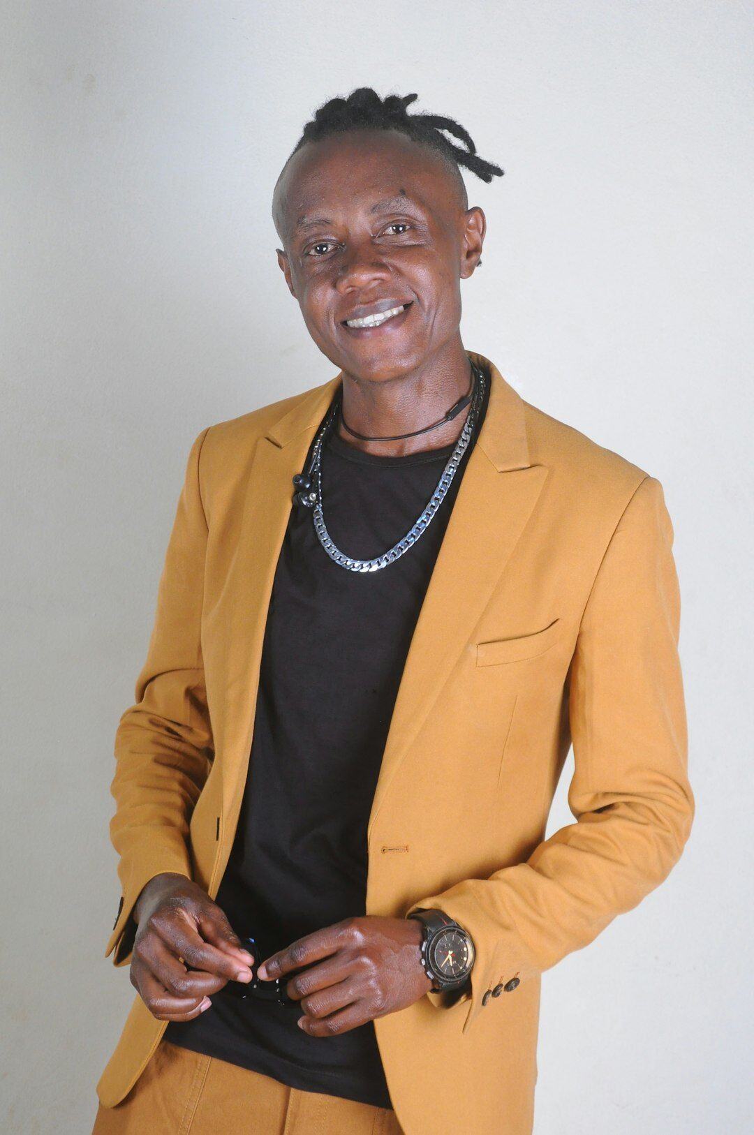 Studio portrait of a man in a suit smiling